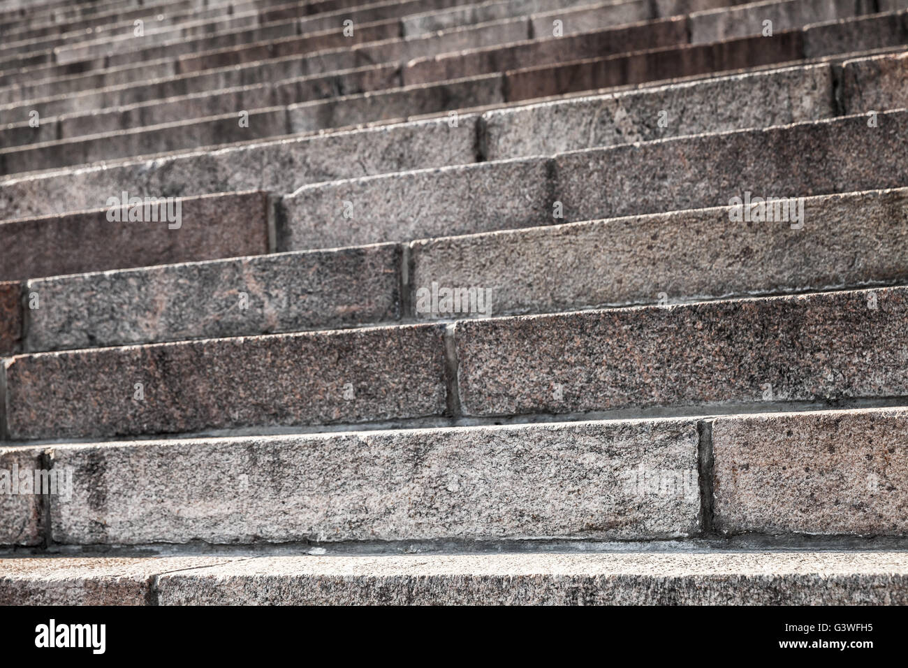 Abstract architecture fragment. Old stairway made of granite stone blocks, close up photo with selective focus Stock Photo