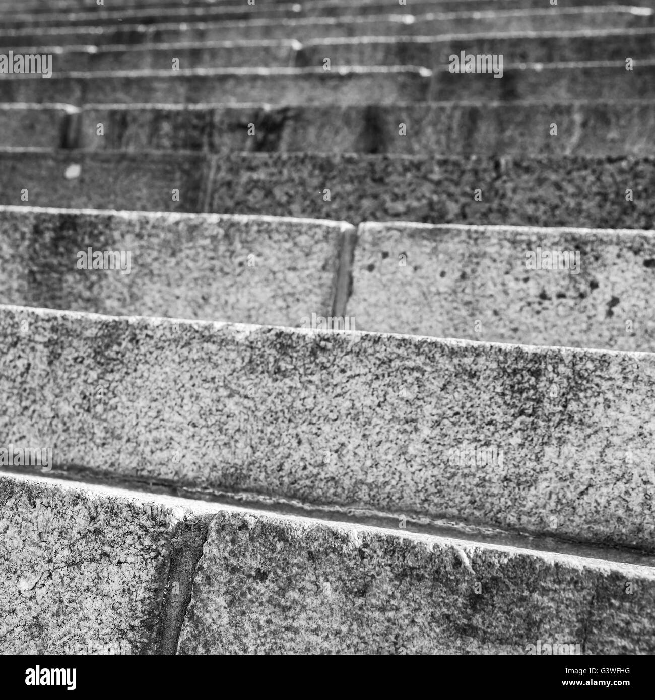 Abstract architecture fragment. Old stairway made of gray granite stone blocks, square close-up photo with selective focus Stock Photo