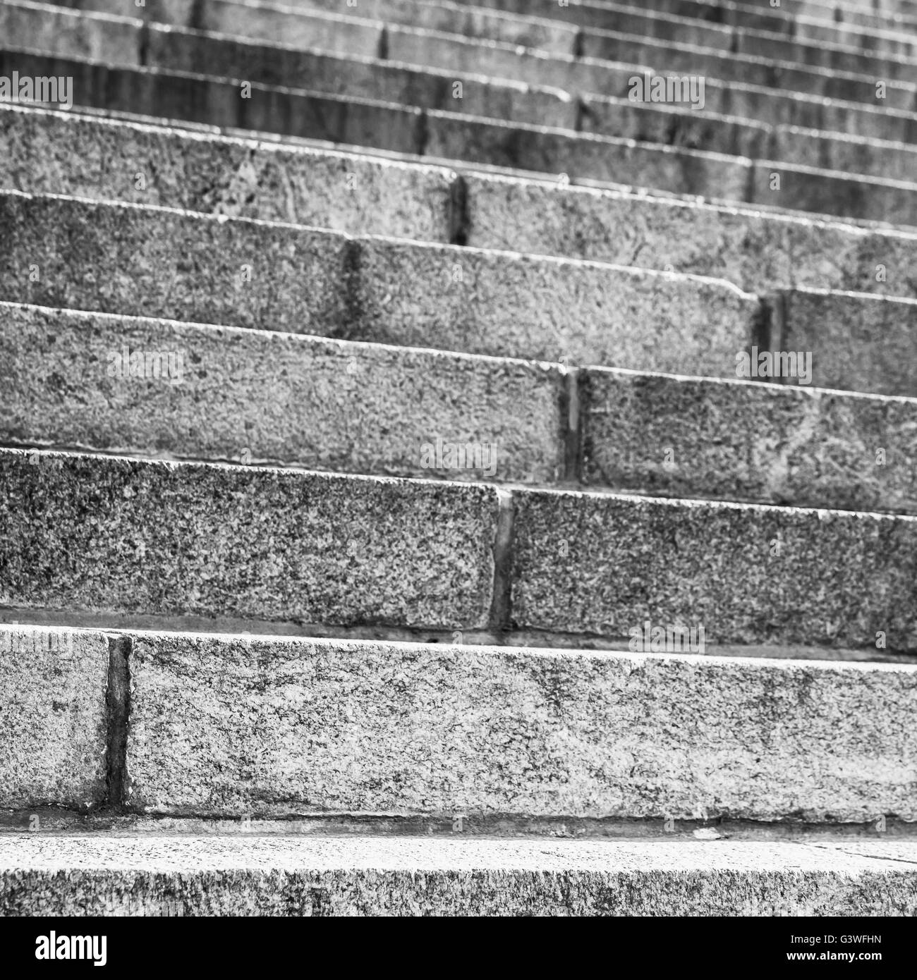 Abstract architecture fragment. Old stairway made of gray granite stone blocks, square closeup photo with selective focus Stock Photo