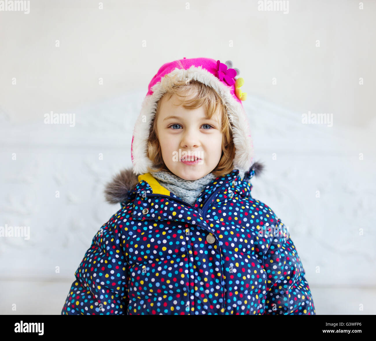Portrait of happy girl wearing winter hat and coat Stock Photo