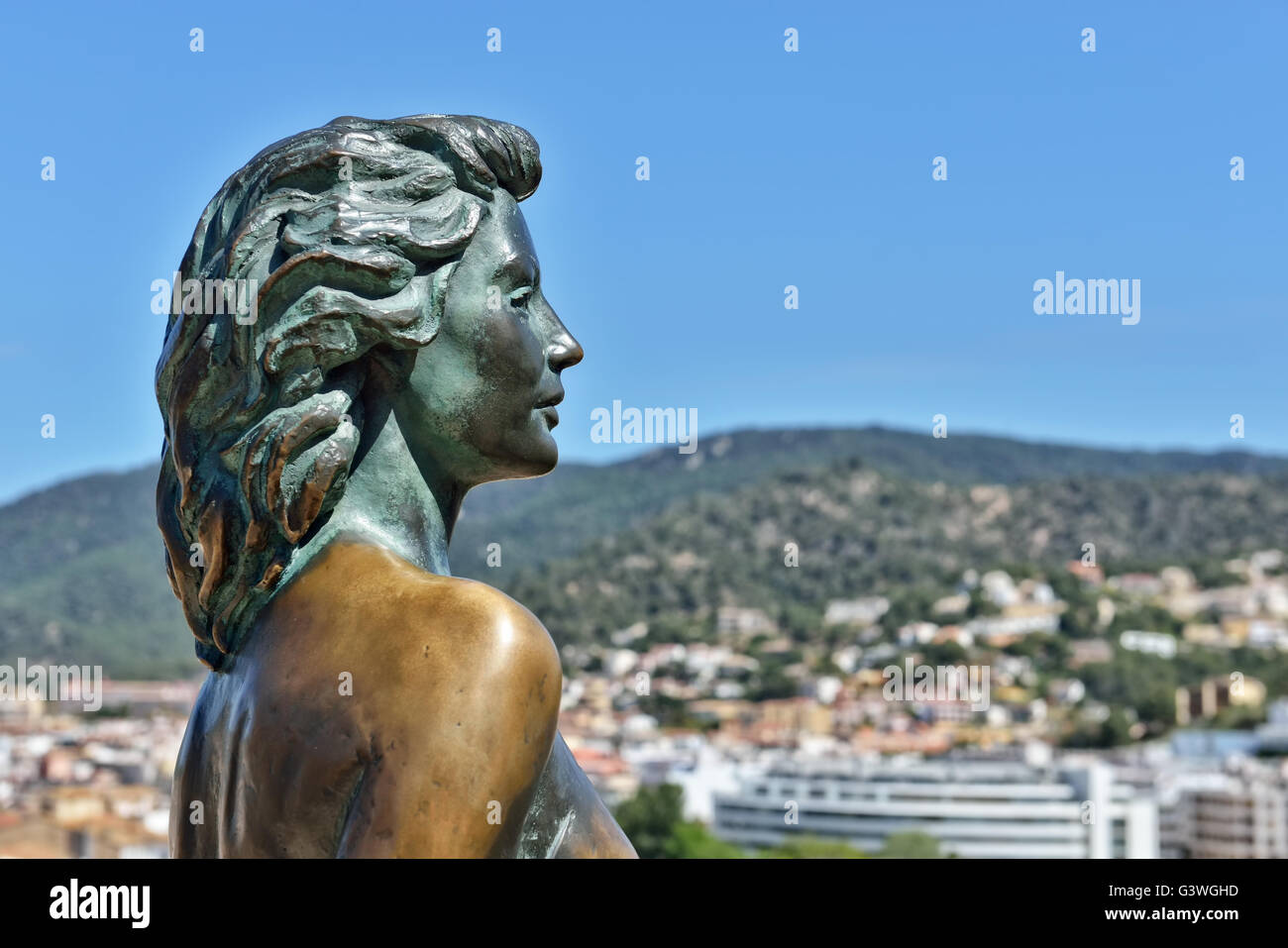 Bronze statue of Ava Gardner looking at panorama of Tossa de Mar, Spain