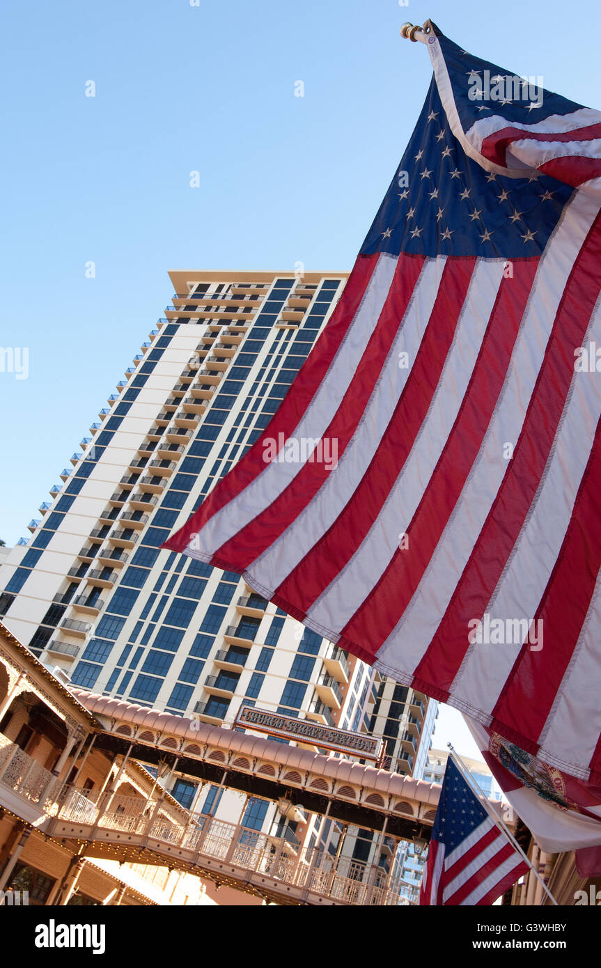 American Flag flying on Church Street Station Orlando Florida with glas
