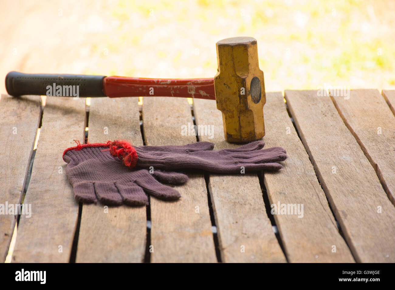 Masonry tool background such as sledgehammer with glove.Background for