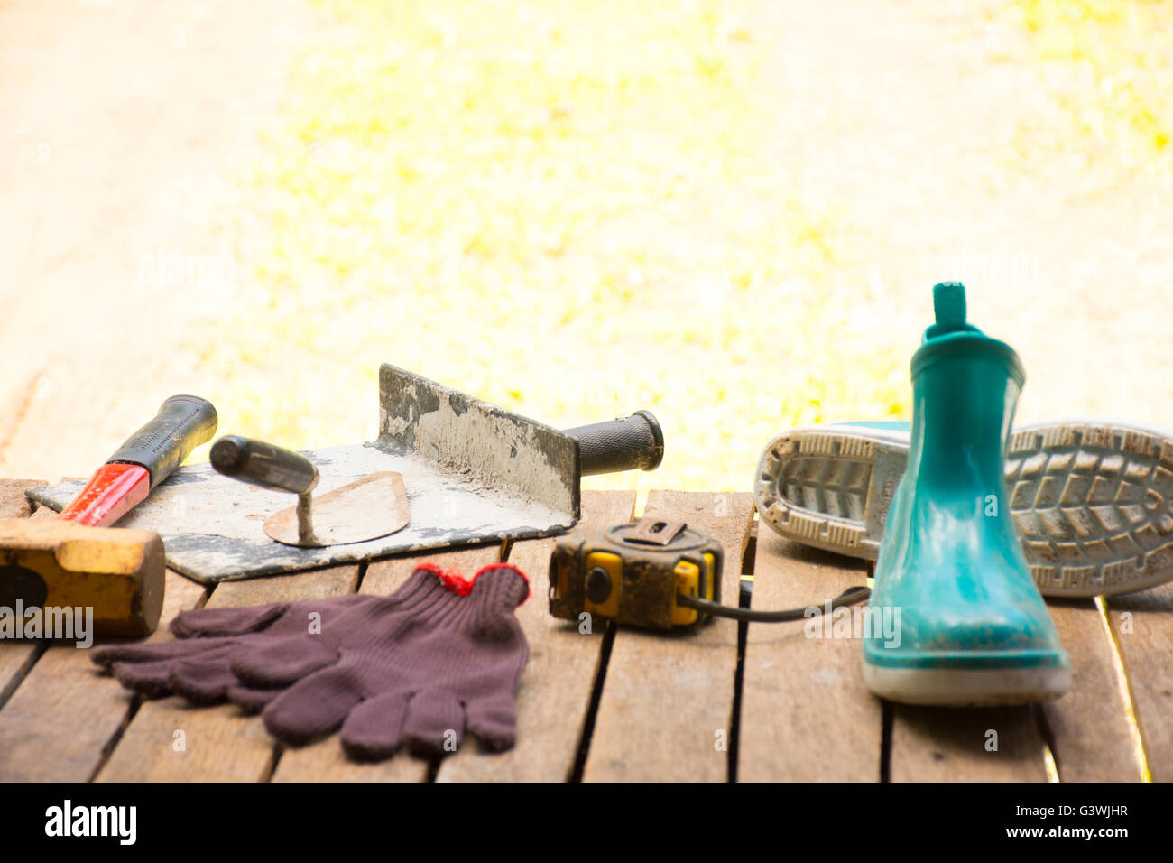Masonry tool background such as glove and tape measure and boot with