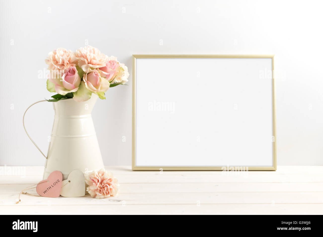 Mockup styled stock photograph of cream jug of flowers next to a Gold frame. You can place your business promotion, blog title, Stock Photo