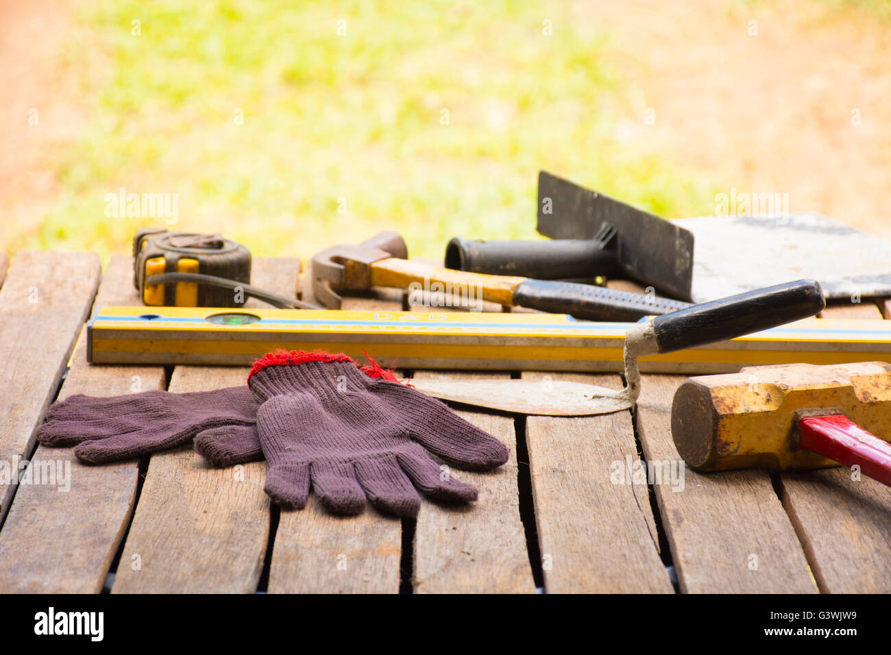 Masonry tool background such as glove and tape measure and sledgehammer