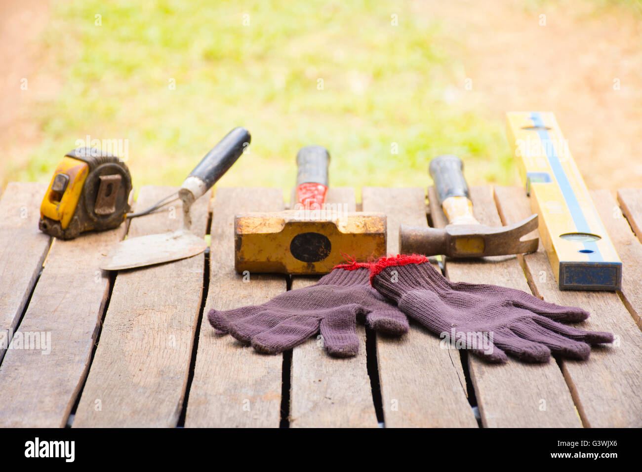 Masonry tool background such as glove and tape measure and sledgehammer