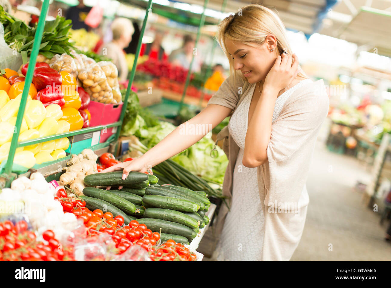 Young woman buying vegetables at the market Stock Photo