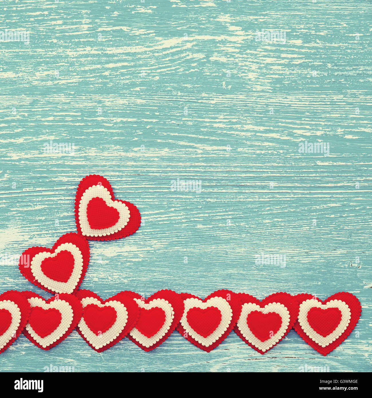 Red hearts on a blue wooden background. Photo in vintage style Stock ...