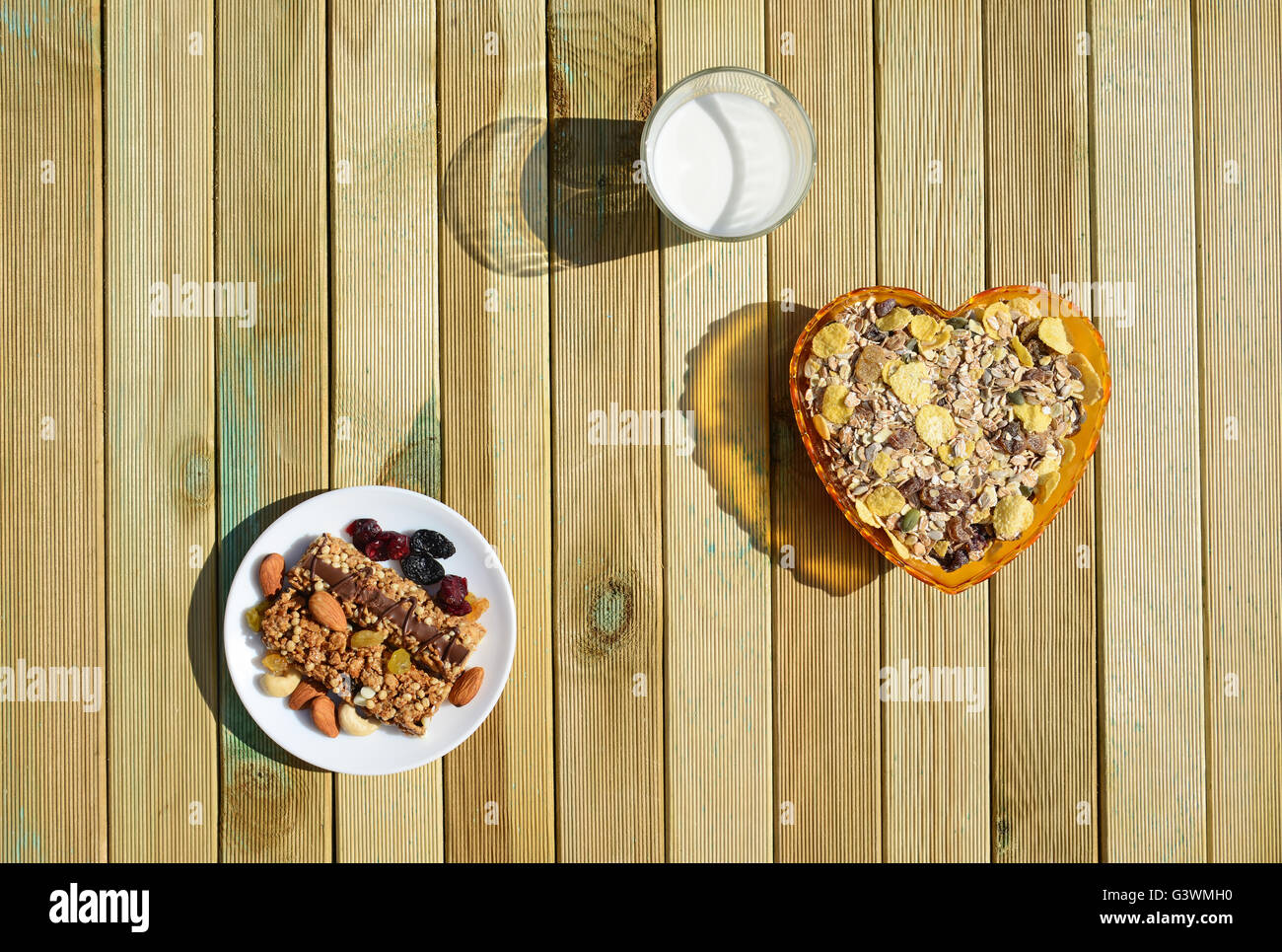 A healthy breakfast with cereal muesli, milk, nuts and berries Stock Photo