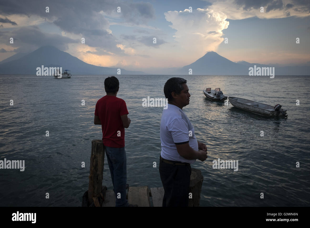 Two men fishing at sunset on lake Atitlan. Stock Photo