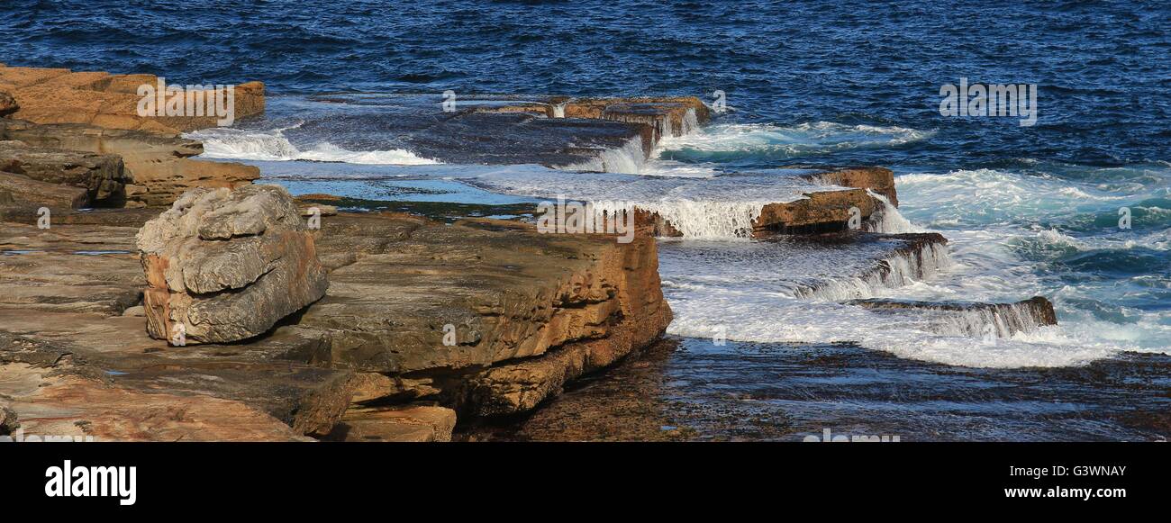 Pacific water flowing over rocks. Stock Photo