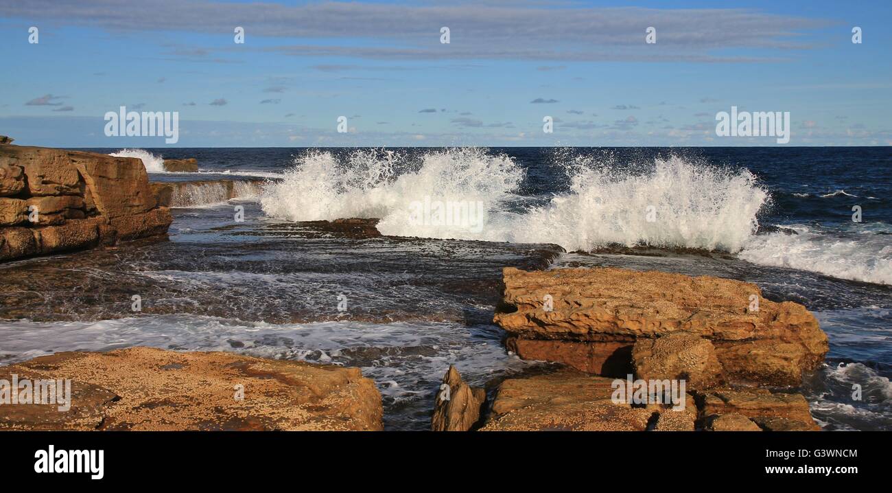 Rocks and splashing waves at Maroubra Beach. Stock Photo