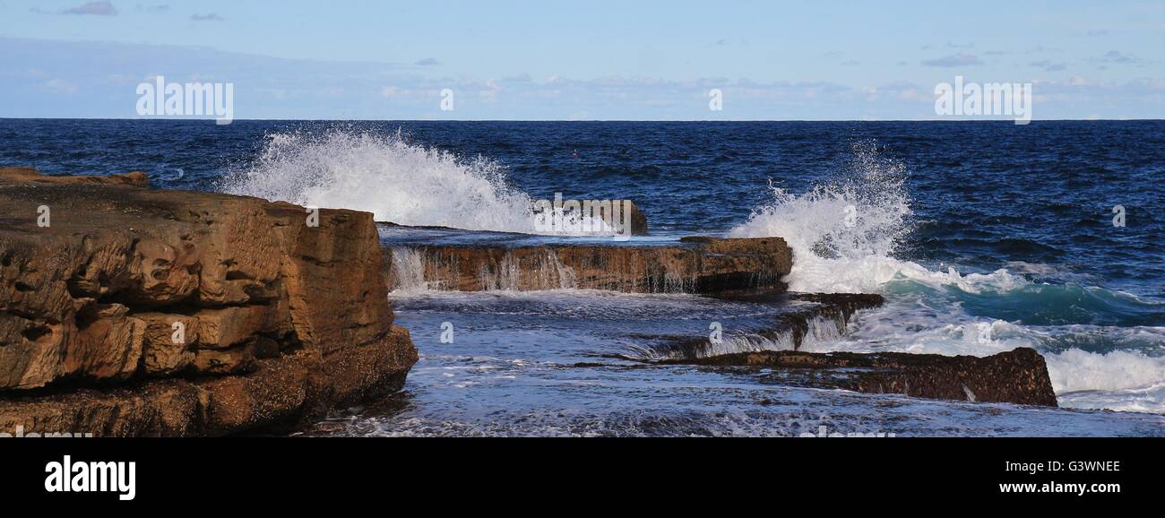 Rocks and splashing Pacific waves. Stock Photo