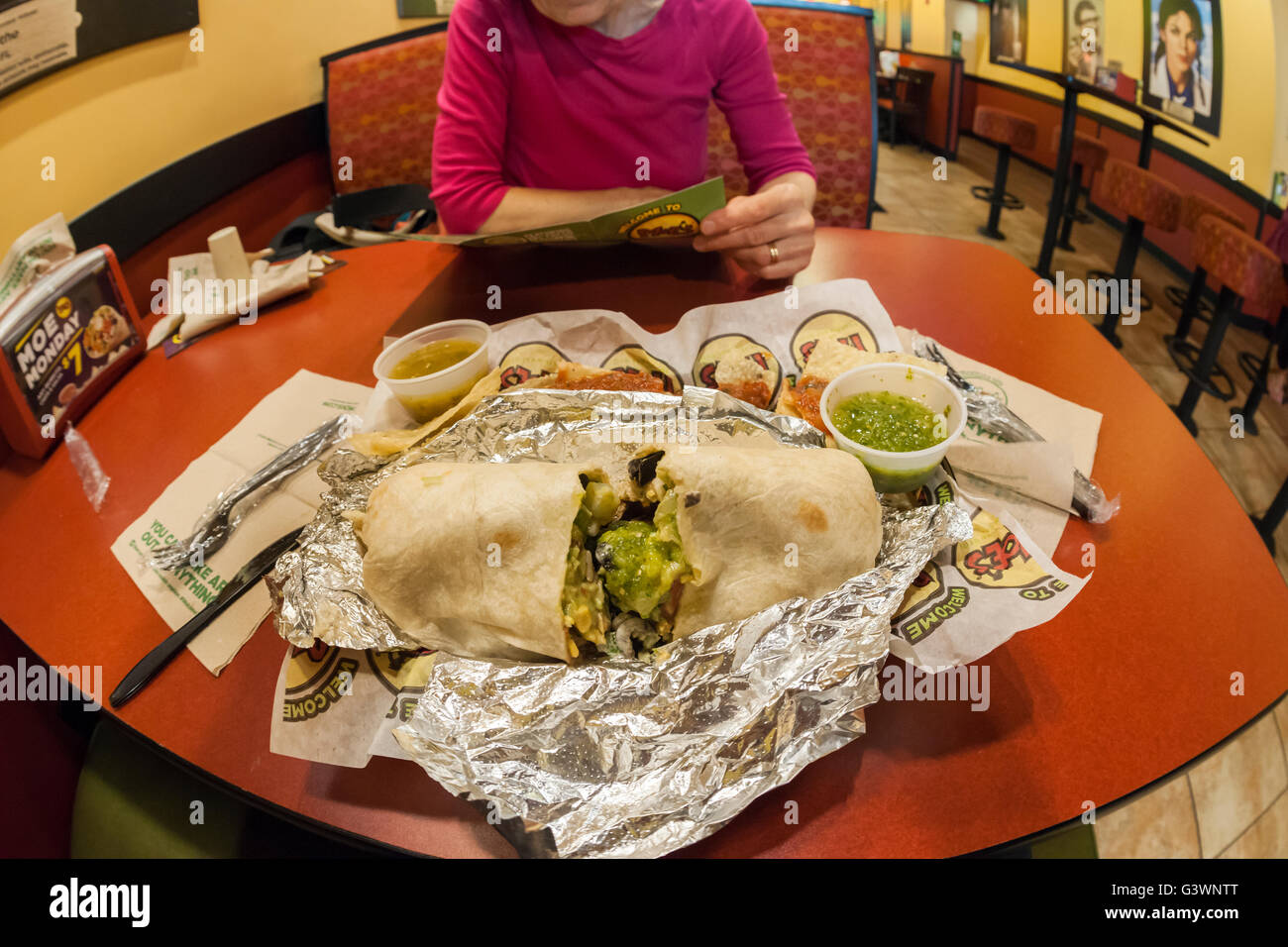 A burrito with chips and salsa in a Moe's Southwest Grill restaurant in