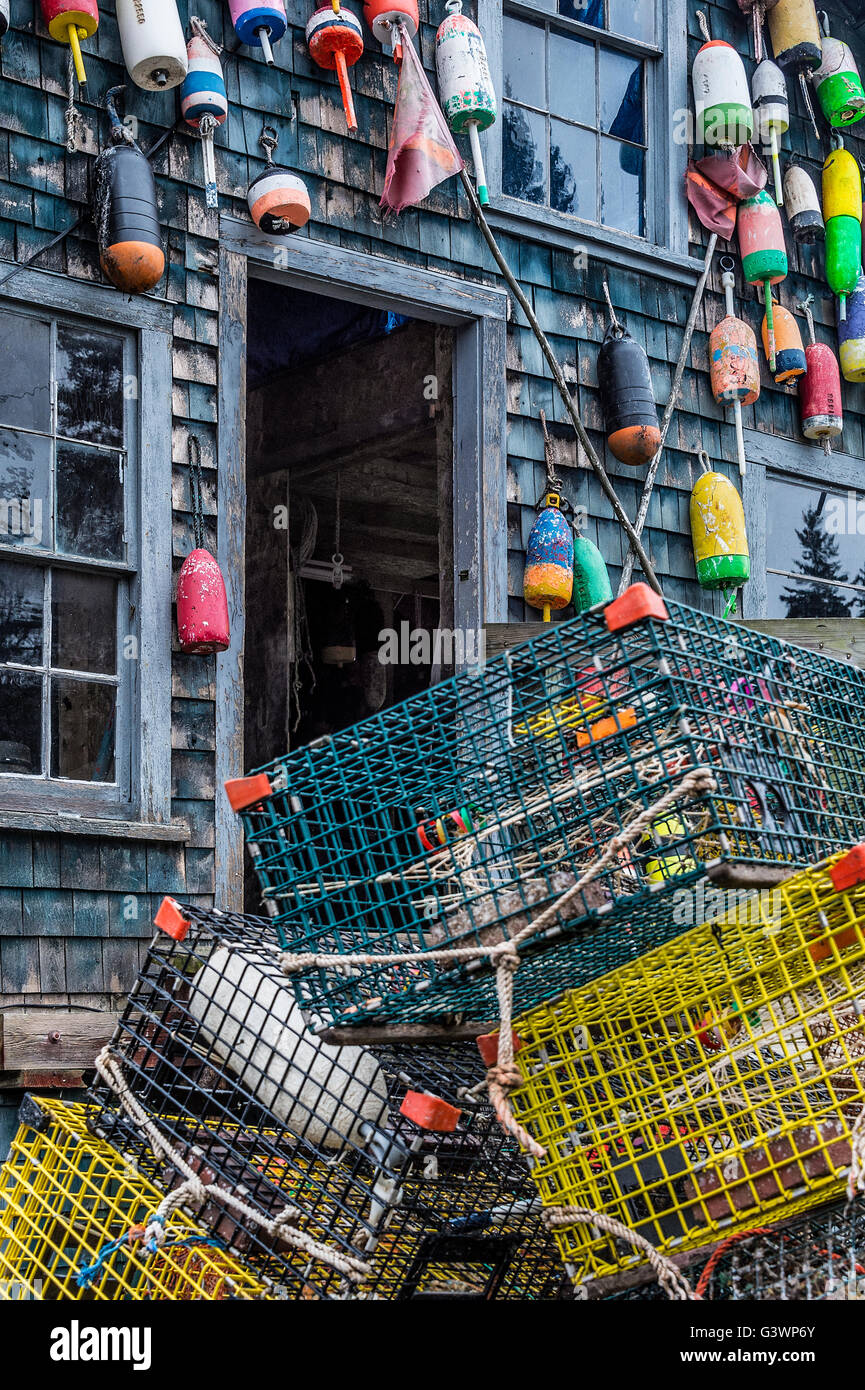 Colorful buoys adorn a rustic coastal shack, Bernard, Mt Desert Island, Maine, USA Stock Photo