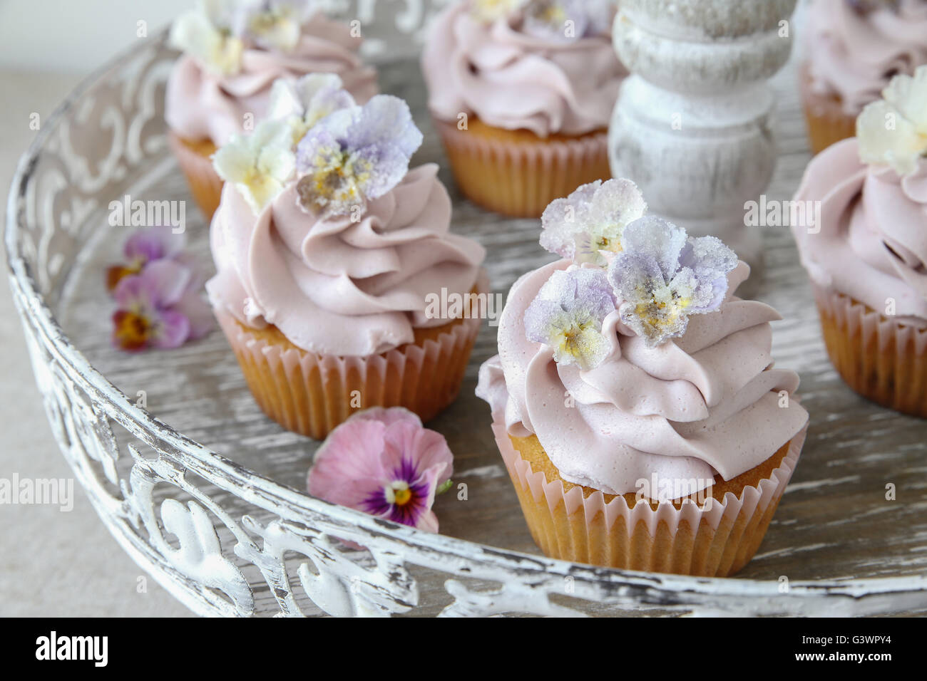 Purple cupcakes with sugared edible flowers on vintage cake stand Stock  Photo - Alamy