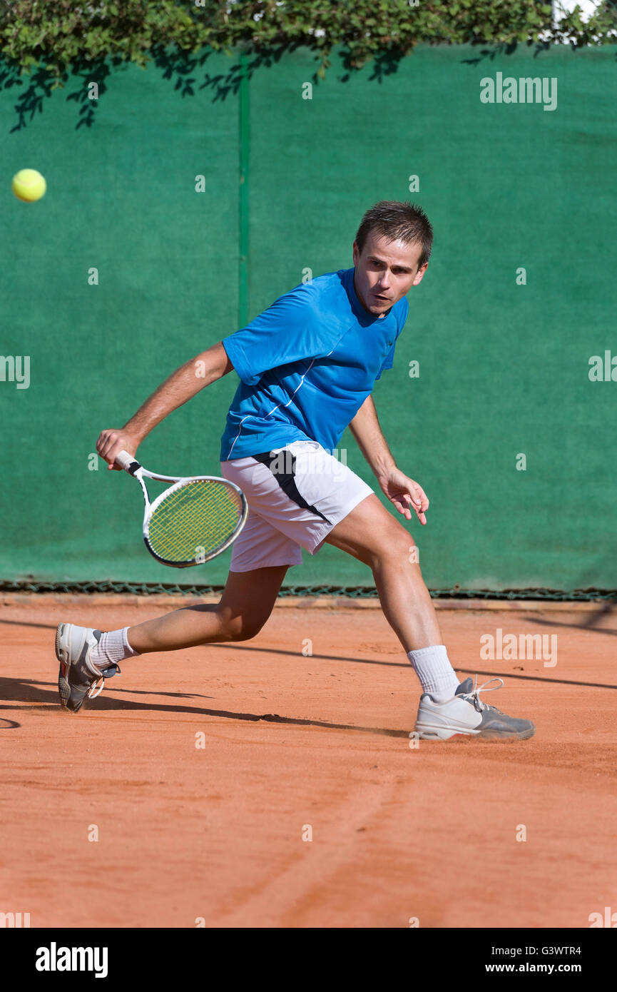 Young man playing tennis Stock Photo