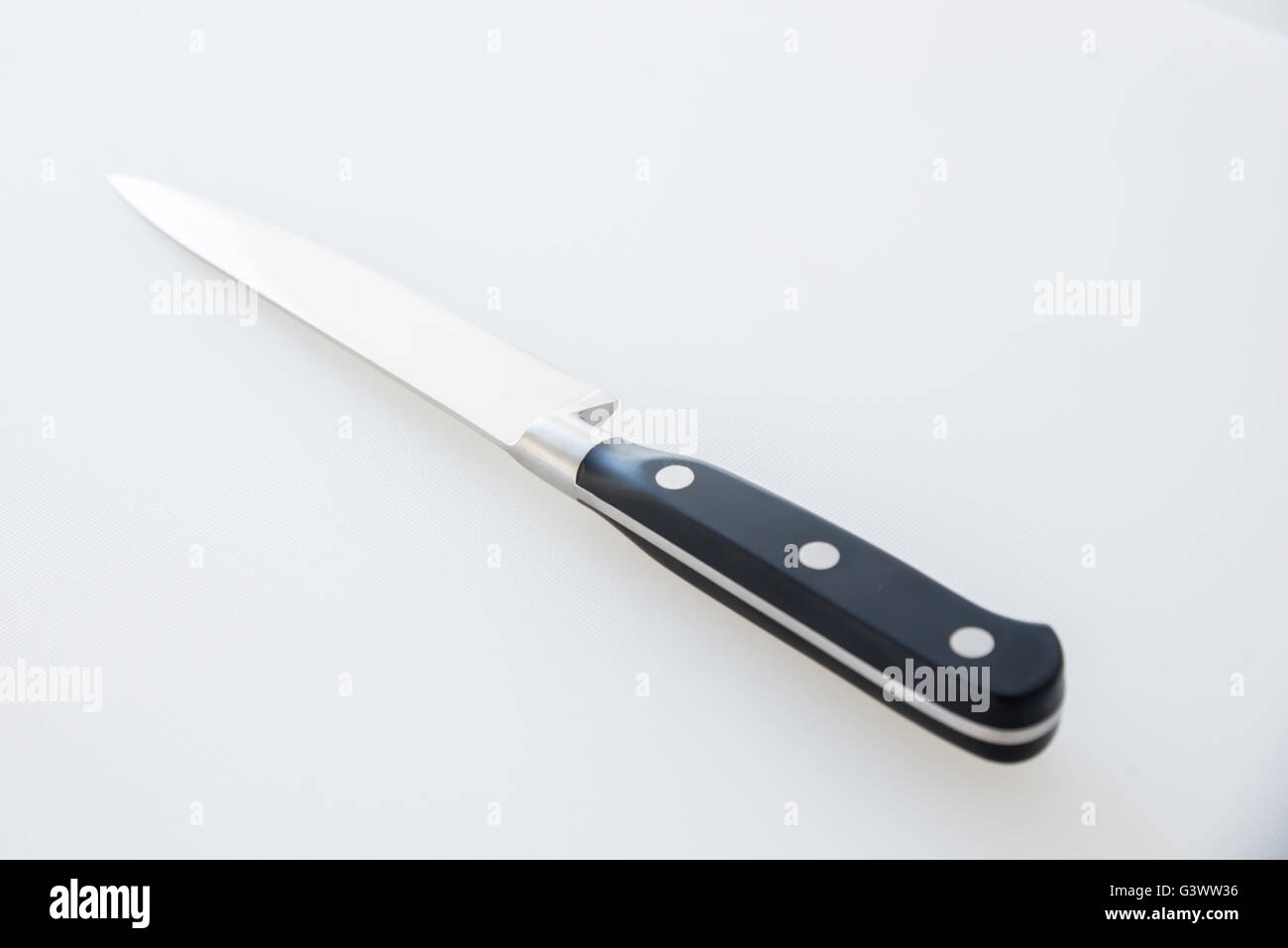 Cutting board and kitchen knife on a white background Stock Photo
