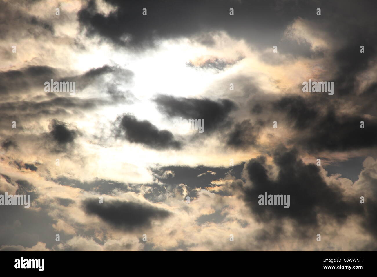 Sun shining through dark passing storm clouds in the sky Stock Photo ...