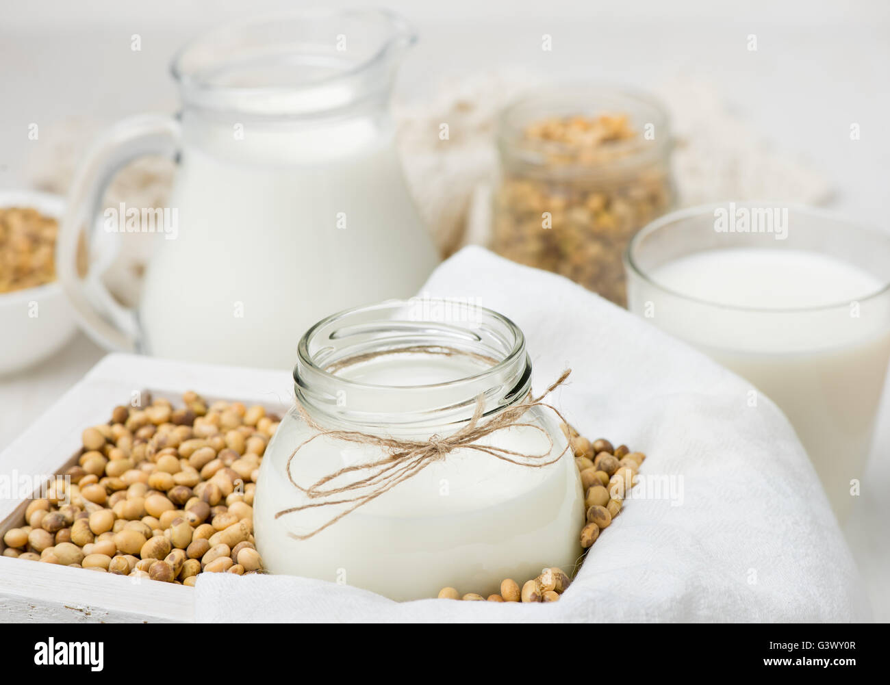 Soy milk in a glass jar and soybeans Stock Photo Alamy