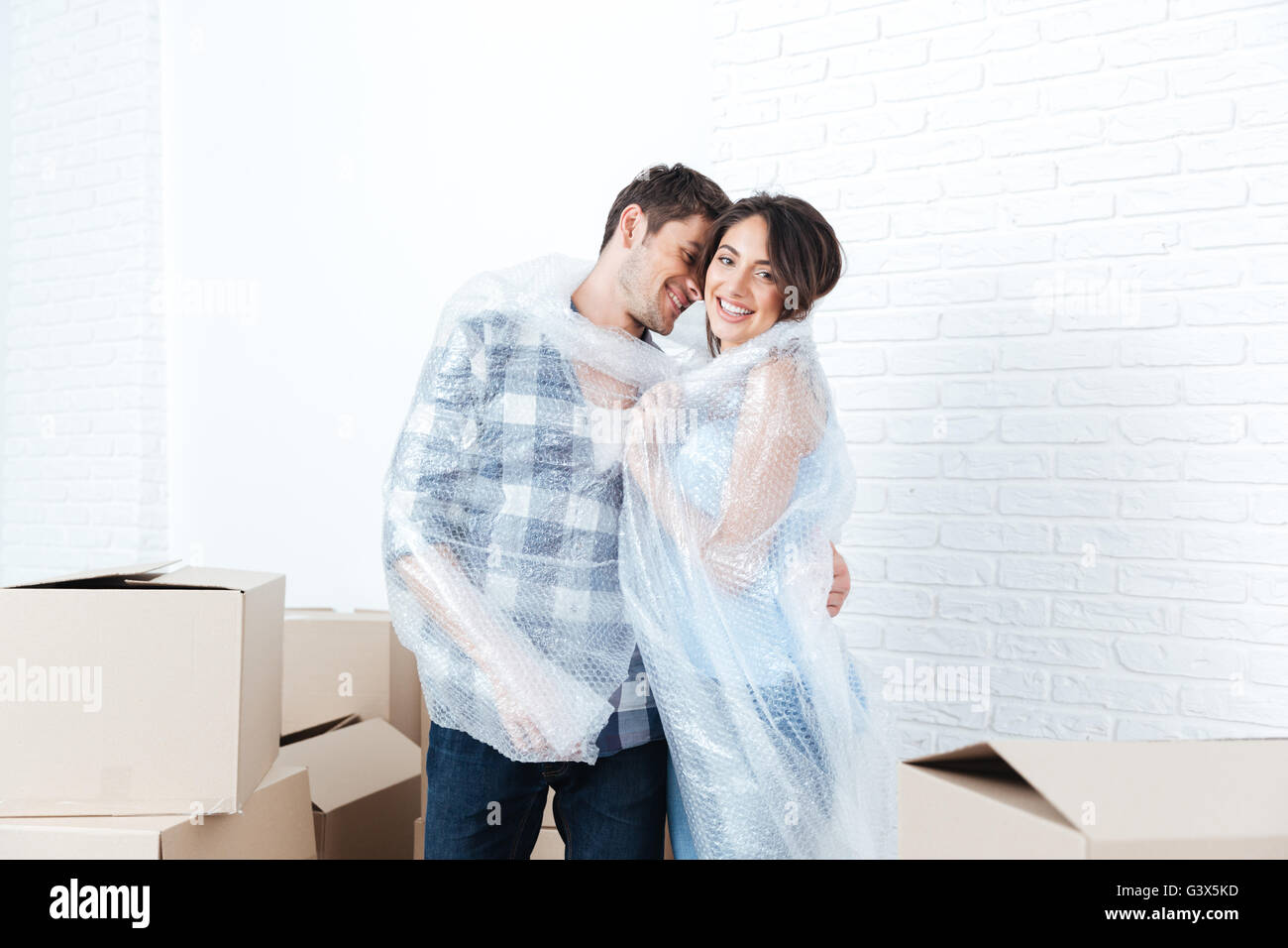 Young pretty happy married couple moving in new flat Stock Photo - Alamy