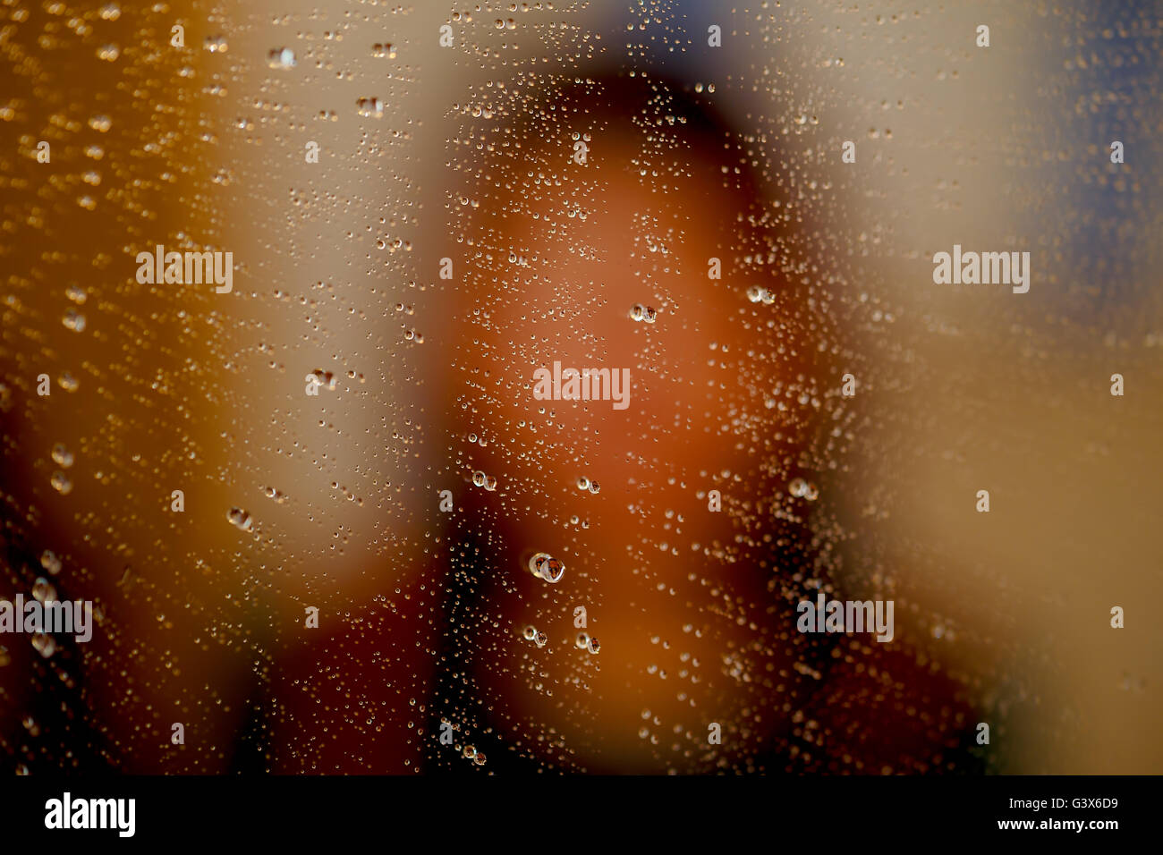 misty reflection of girl in the mirror with water droplets Stock Photo