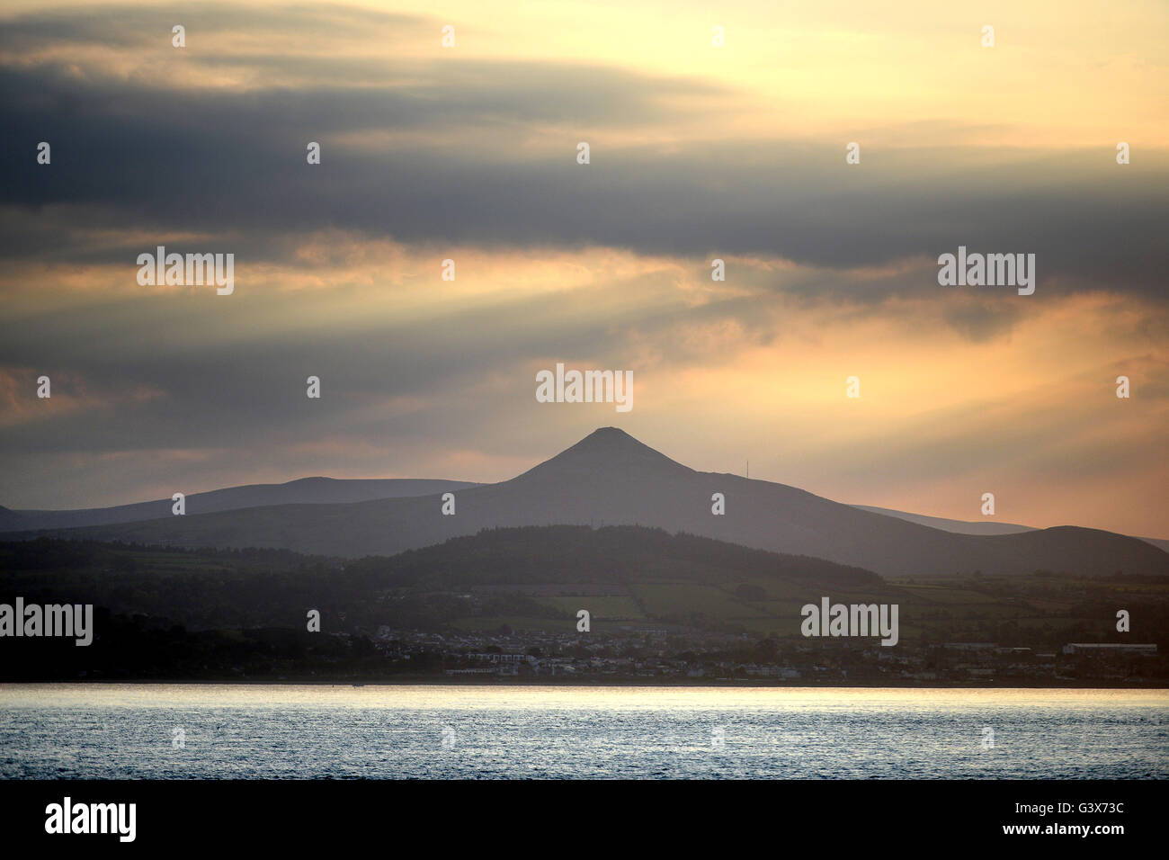 Evening sun over Wicklow Mountains national Park, Leinster, Ireland with Great Sugar Loaf hill, taken from the Irish sea Stock Photo