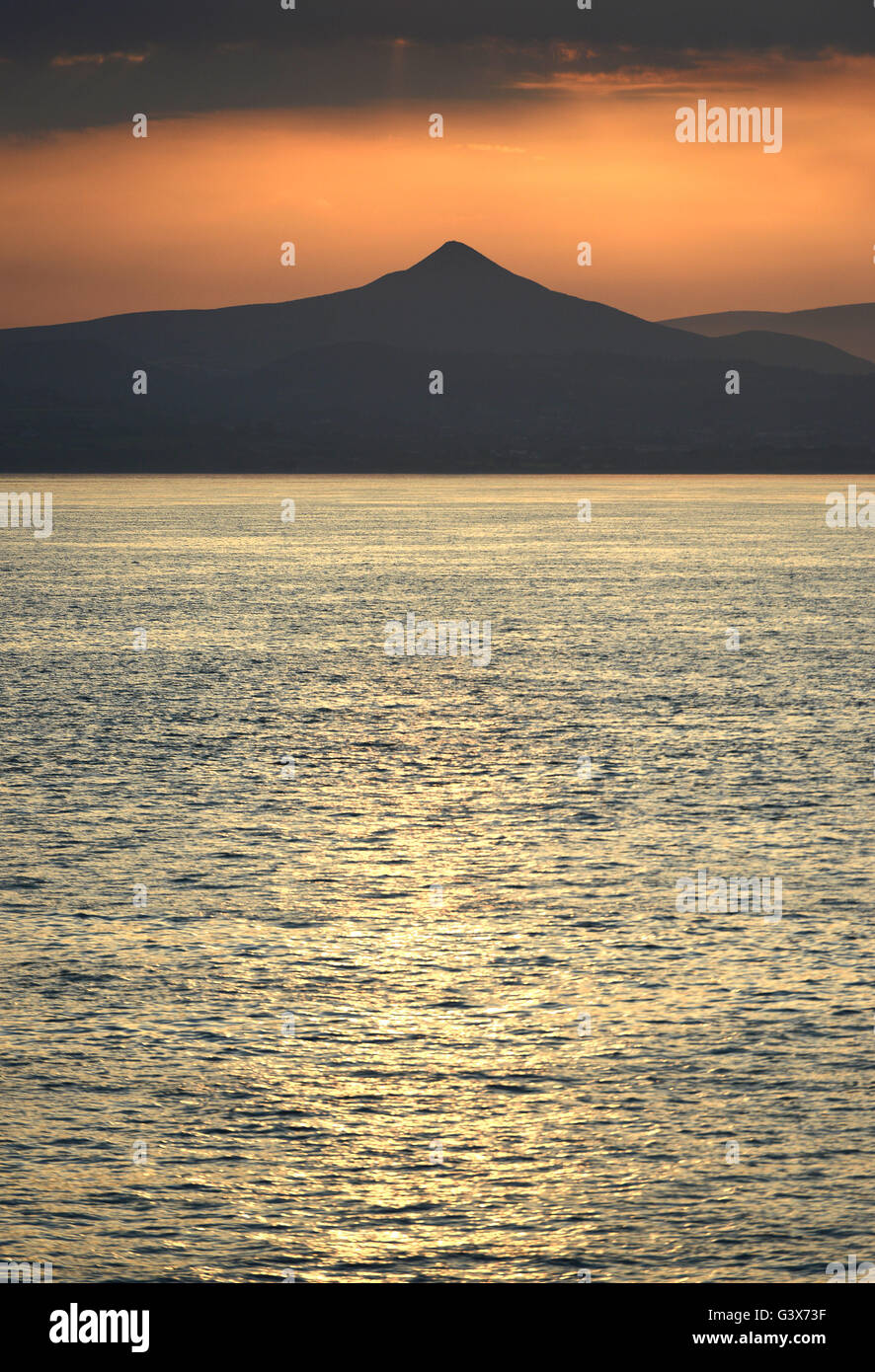 Evening sun over Wicklow Mountains national Park, Leinster, Ireland with Great Sugar Loaf hill, taken from the Irish sea Stock Photo