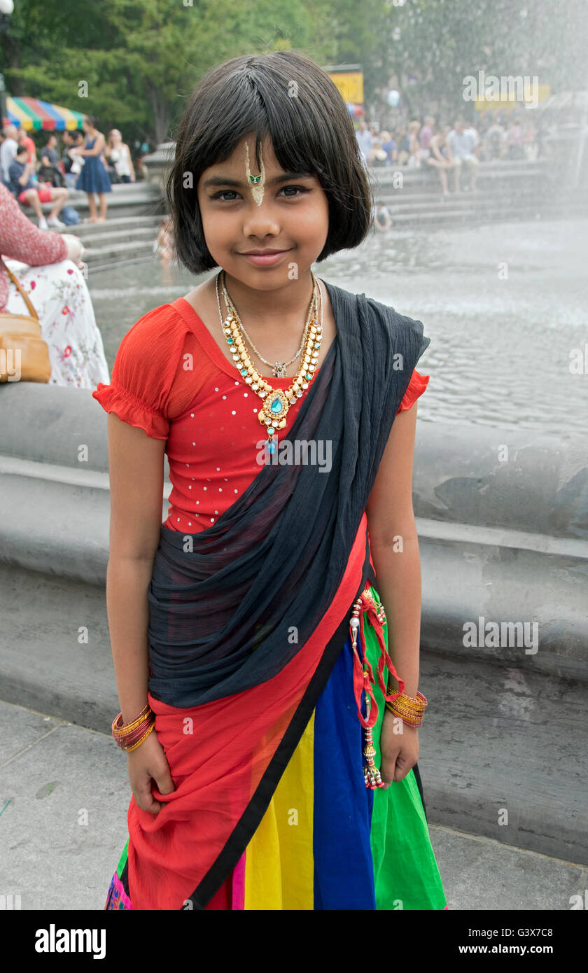 A 10 year old girl from Bangladesh in a traditional colorful dress in Washington Square Park in New York City. Stock Photo