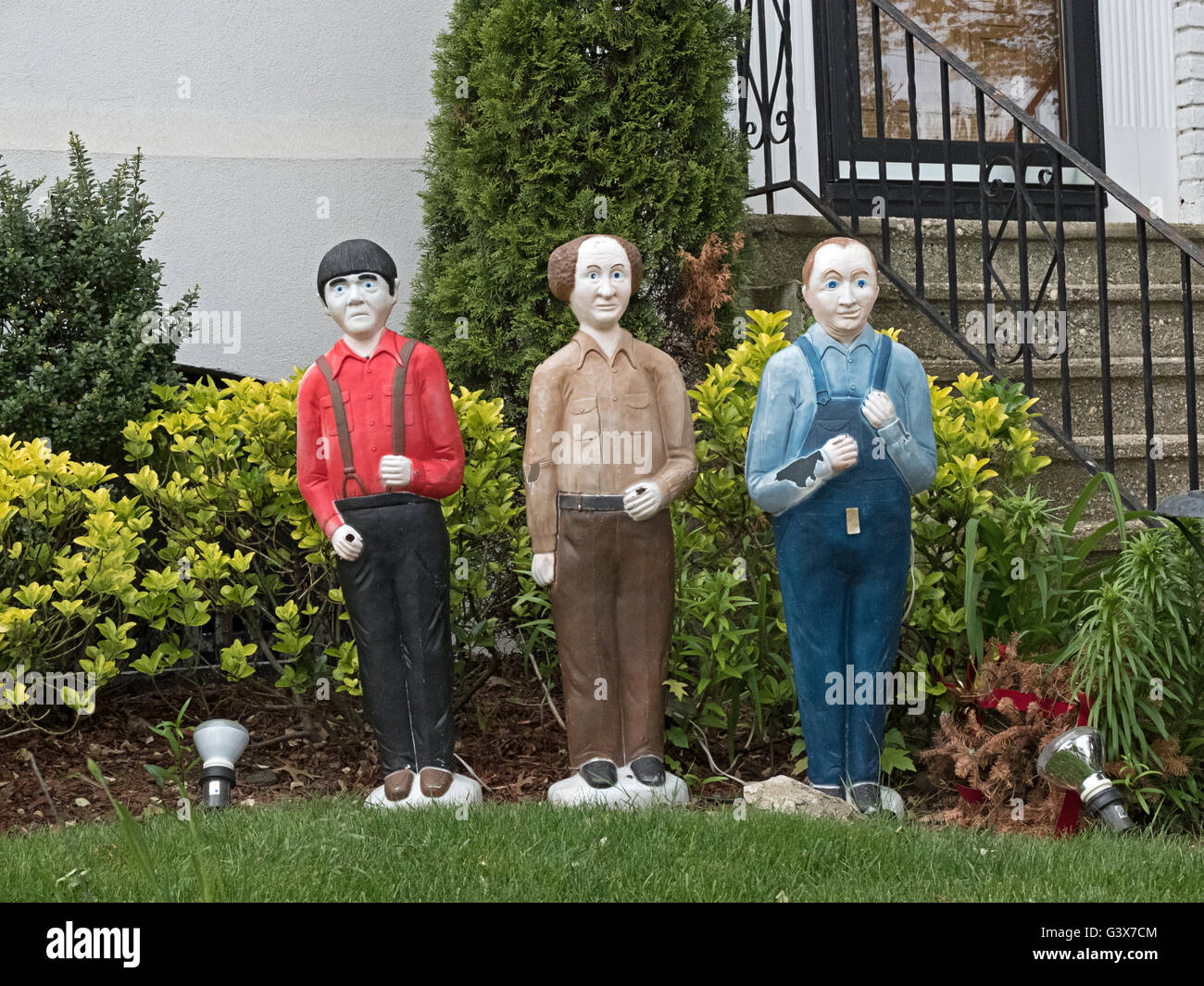 Front lawn garden gnomes shaped like the Three Stooges. In FLushing, Queens, New York City. Stock Photo