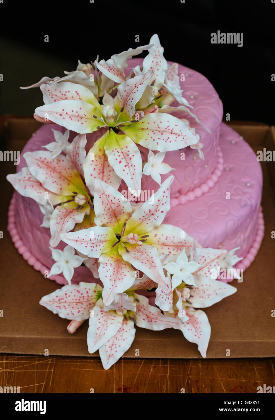 pink Wedding Cake Lily flower topper Stock Photo