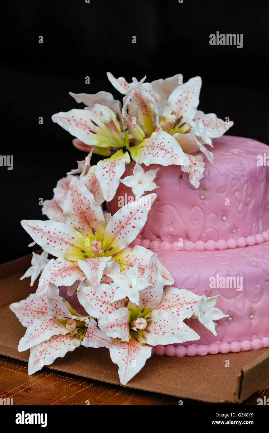 pink Wedding Cake Lily flower topper Stock Photo