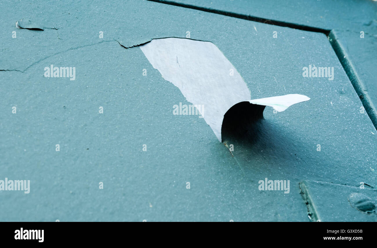 Large piece of green paint cracking and peeling off metal door Stock
