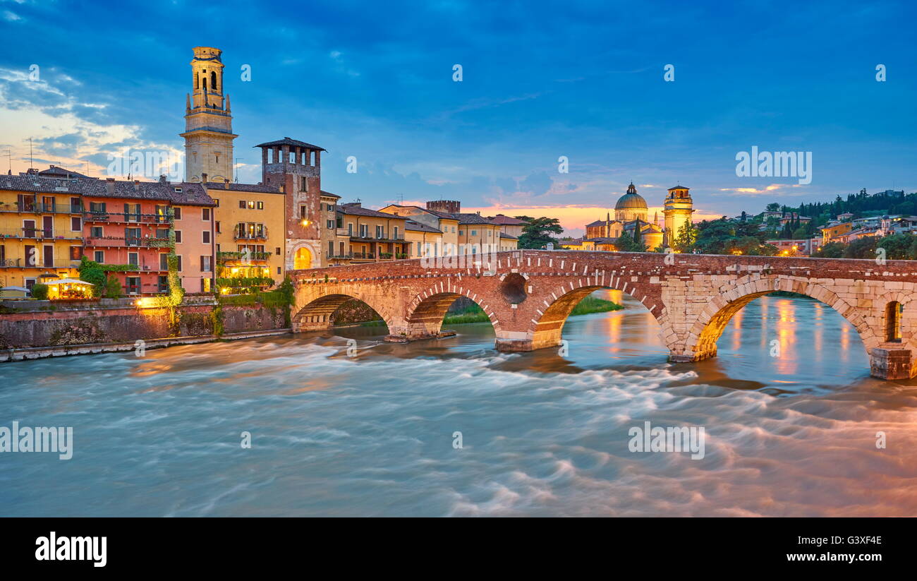Ponte Pietra Bridge at evening dusk, Verona old town, Veneto region, Italy Stock Photo