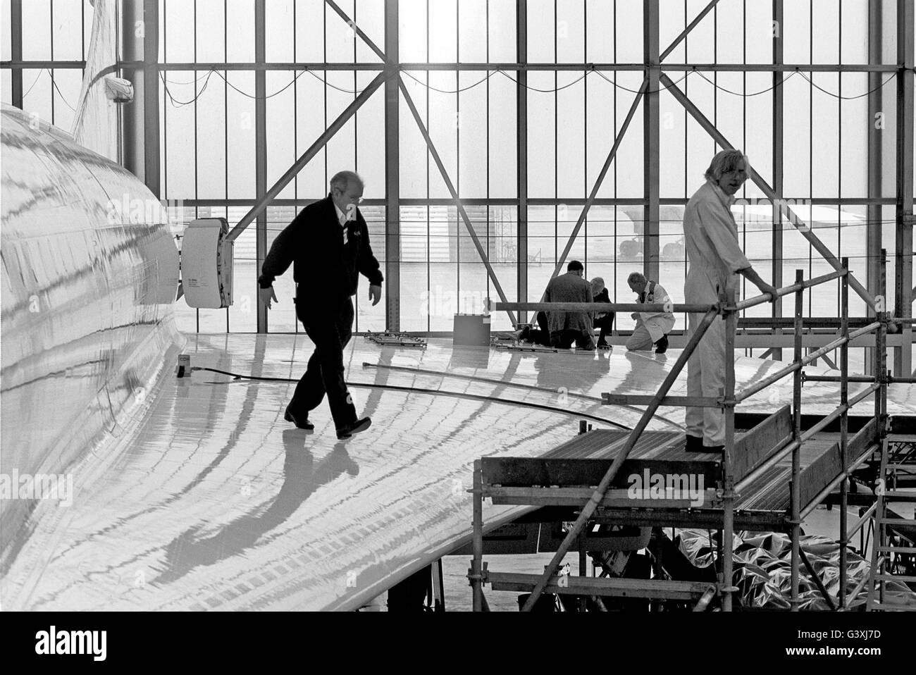 CONCORDE.  Engineers on the wing  of a Concorde  in a British Airways hanger at Heathrow Airport,  March 23rd 2001. They were modifying the fuel tanks to prevent penetration of debris from the runway after the fatal Paris Concorde crash. B&W photograph. Stock Photo