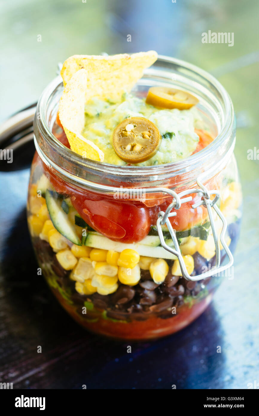 Mexican Salad in a Jar with salsa, lettuce, black beans, corn, zucchini