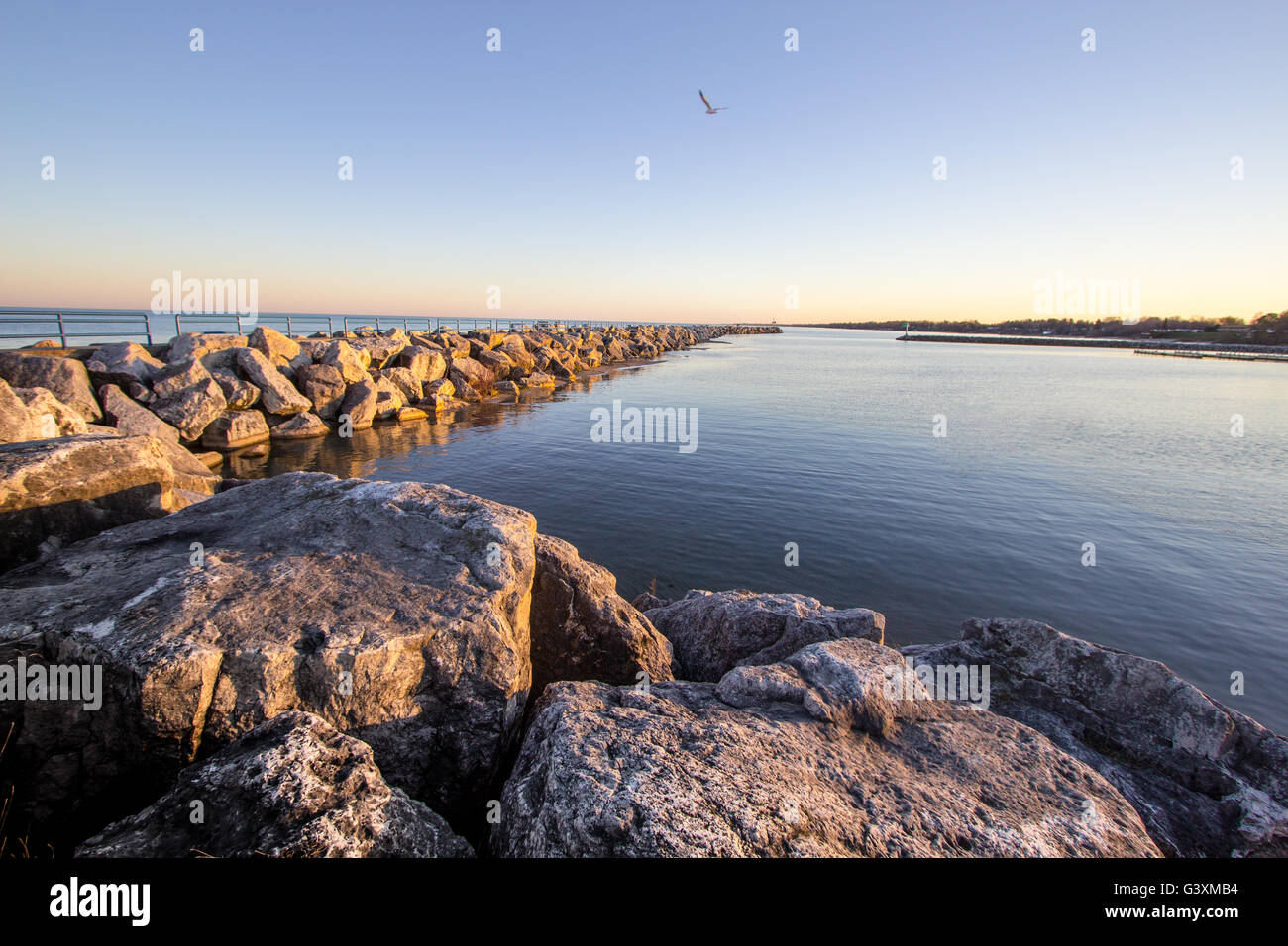 Summer Stroll On The Coast. Harbor break wall along the shores of the Great Lakes on a warm summer evening. Lexington, Michigan Stock Photo