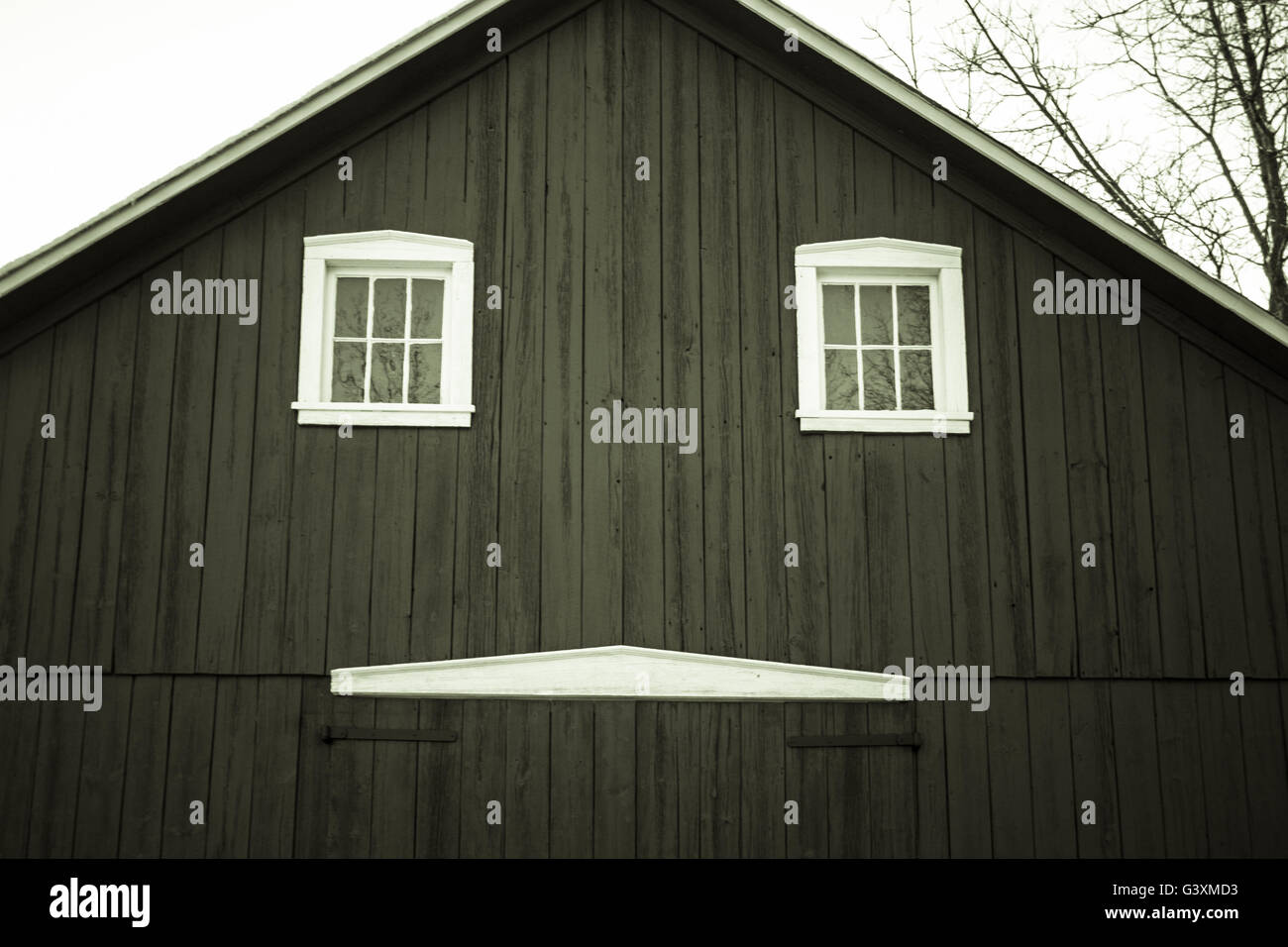 The Happy Barn. Front of a traditional wooden barn with an abstract smiley face in America's Midwest. Stock Photo