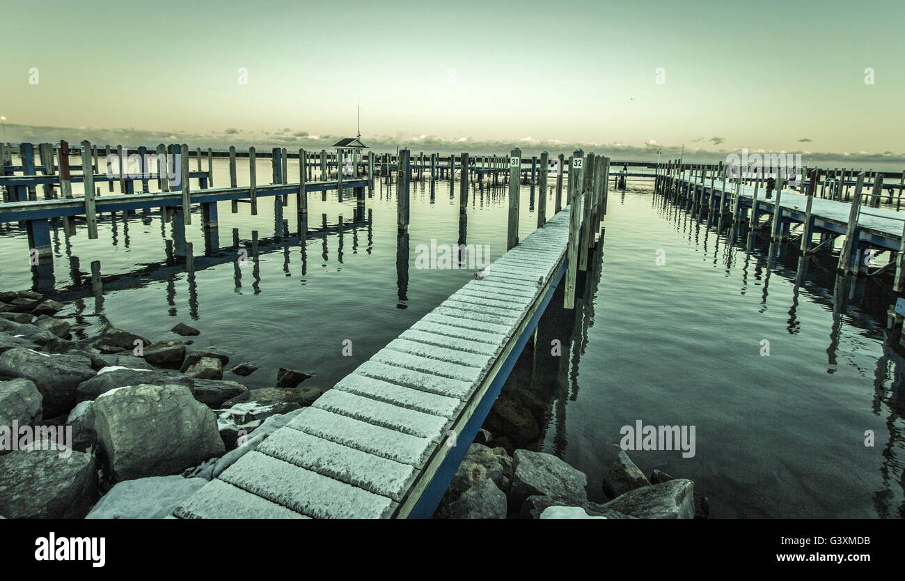 Lake Huron Gray. Snow falls on an abandoned marina as winter settles in over the coast of Lake Huron. Stock Photo