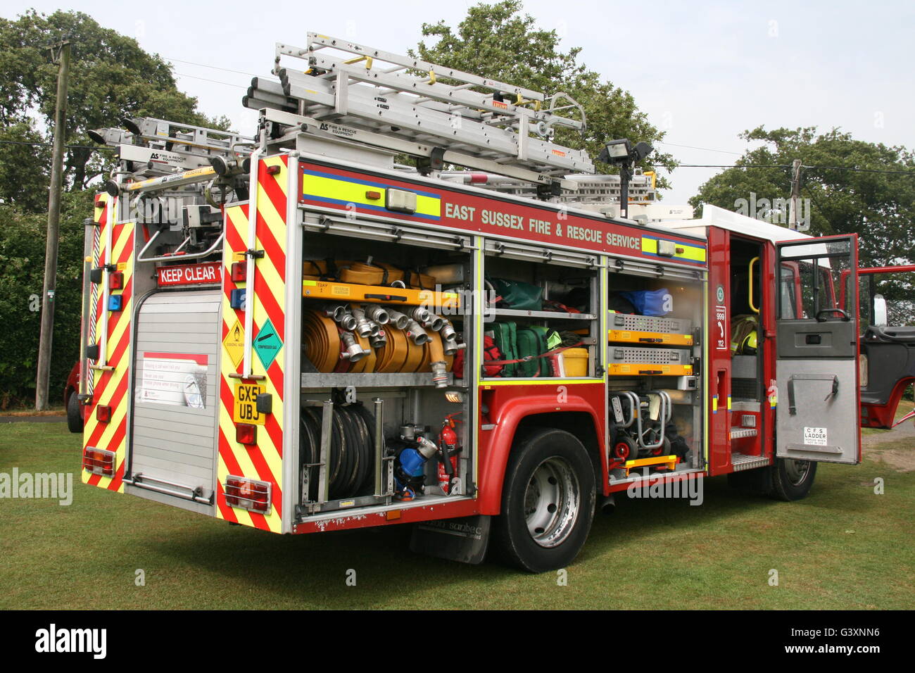 REAR VIEW OF VOLVO FIRE TRUCK OF EAST SUSSEX FIRE & RESCUE WITH DOORS OPEN SHOWING ALL EQUIPMENT Stock Photo