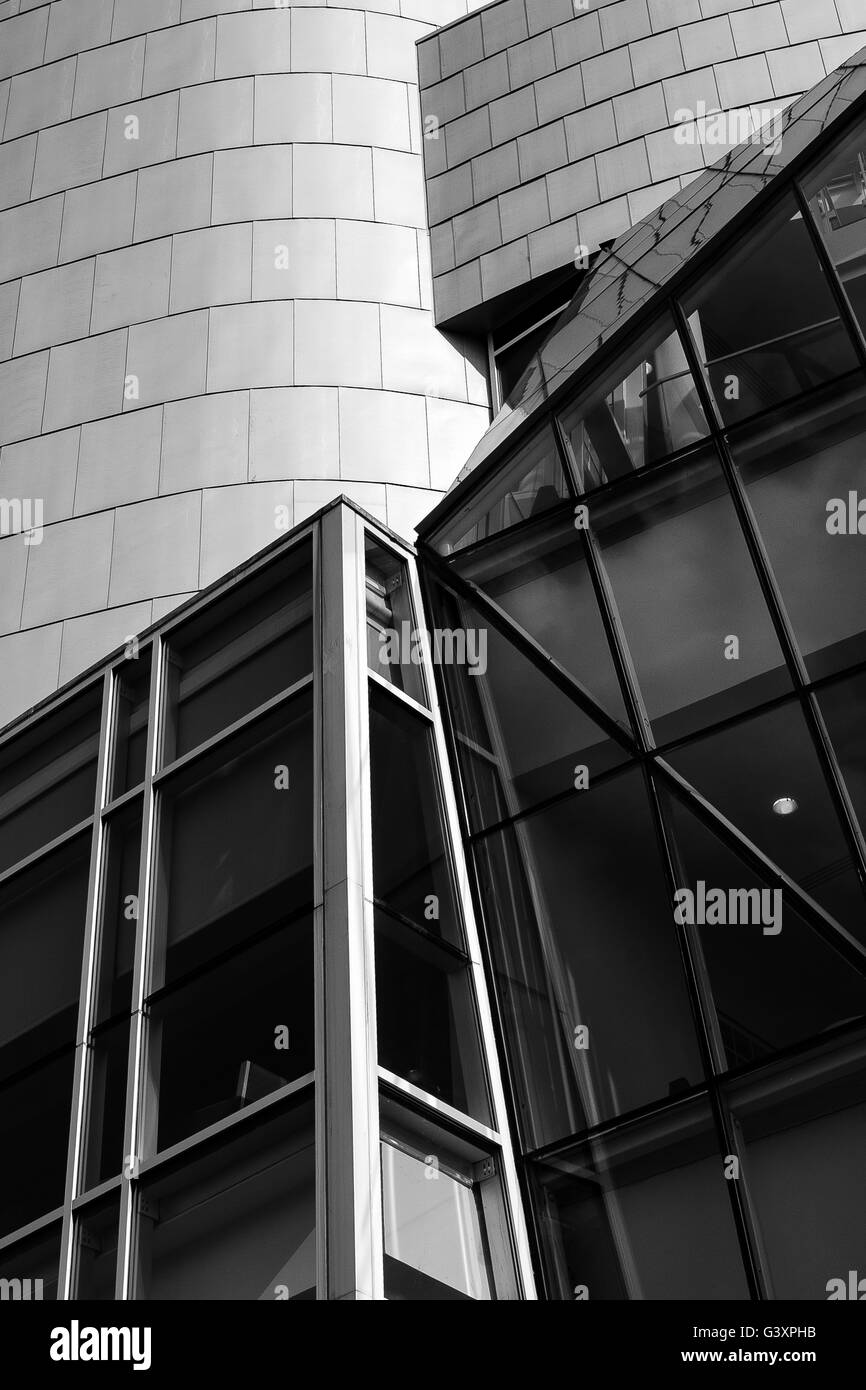 Angles and curves in abstract detail of glass and metal facade of