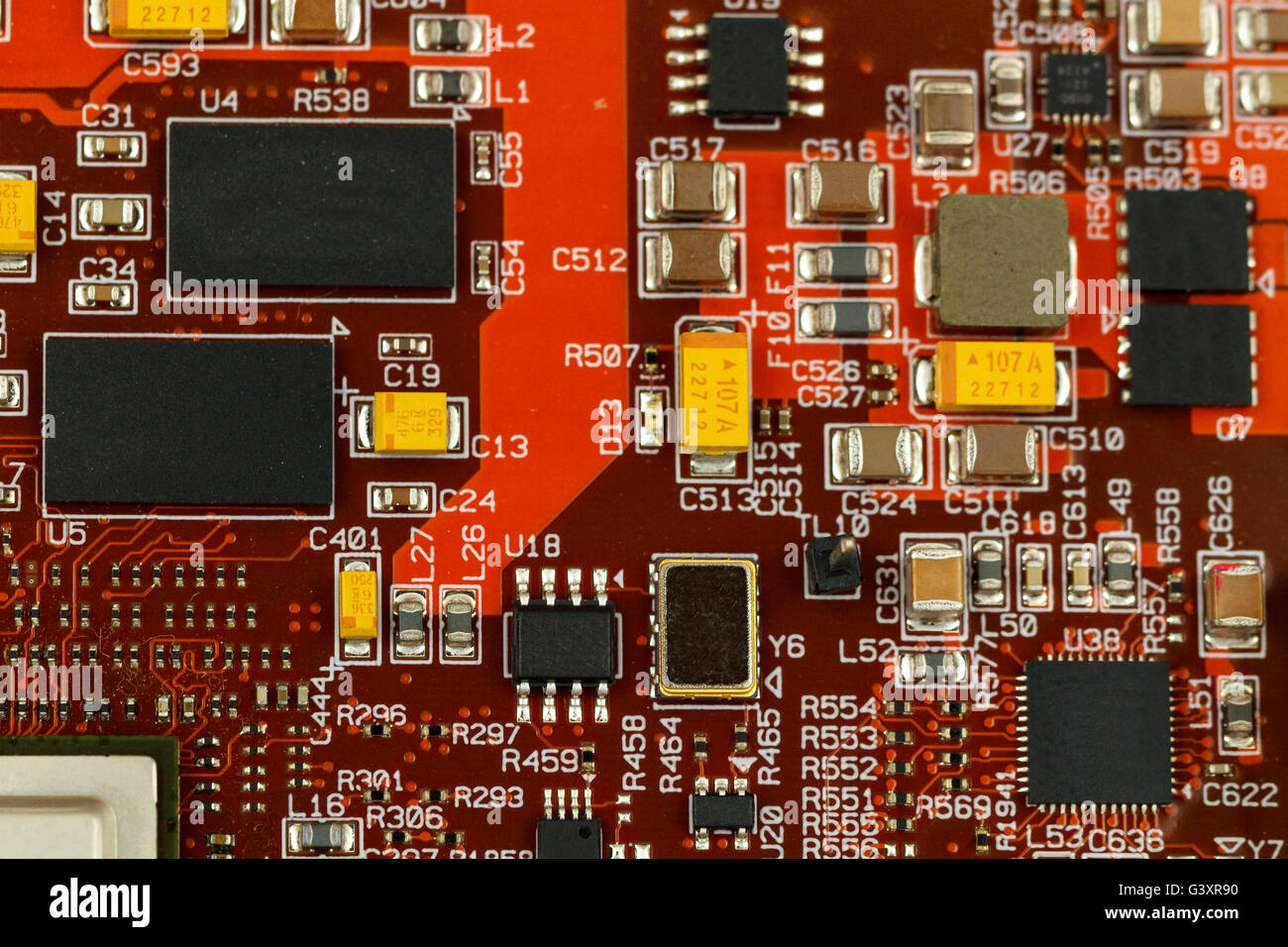 Printed circuit board with ICs, chip capacitors, tantalum capacitors, and chip resistors. Stock Photo