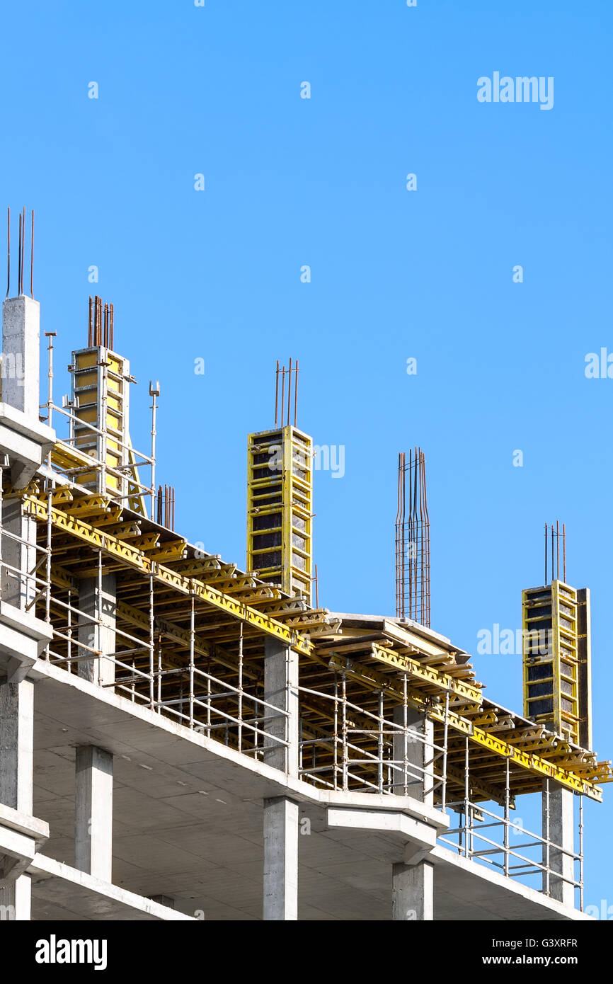 Concrete building under construction against blue sky Stock Photo - Alamy