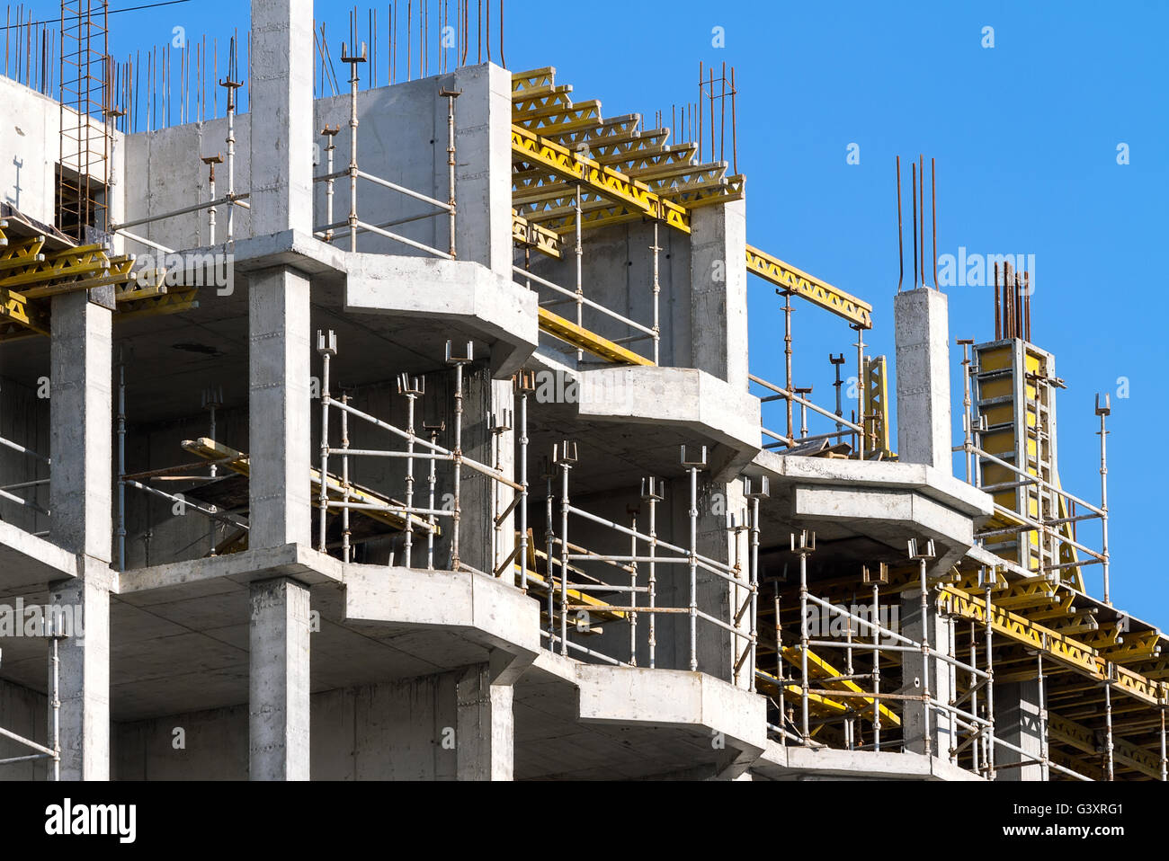 Concrete building under construction against blue sky Stock Photo - Alamy