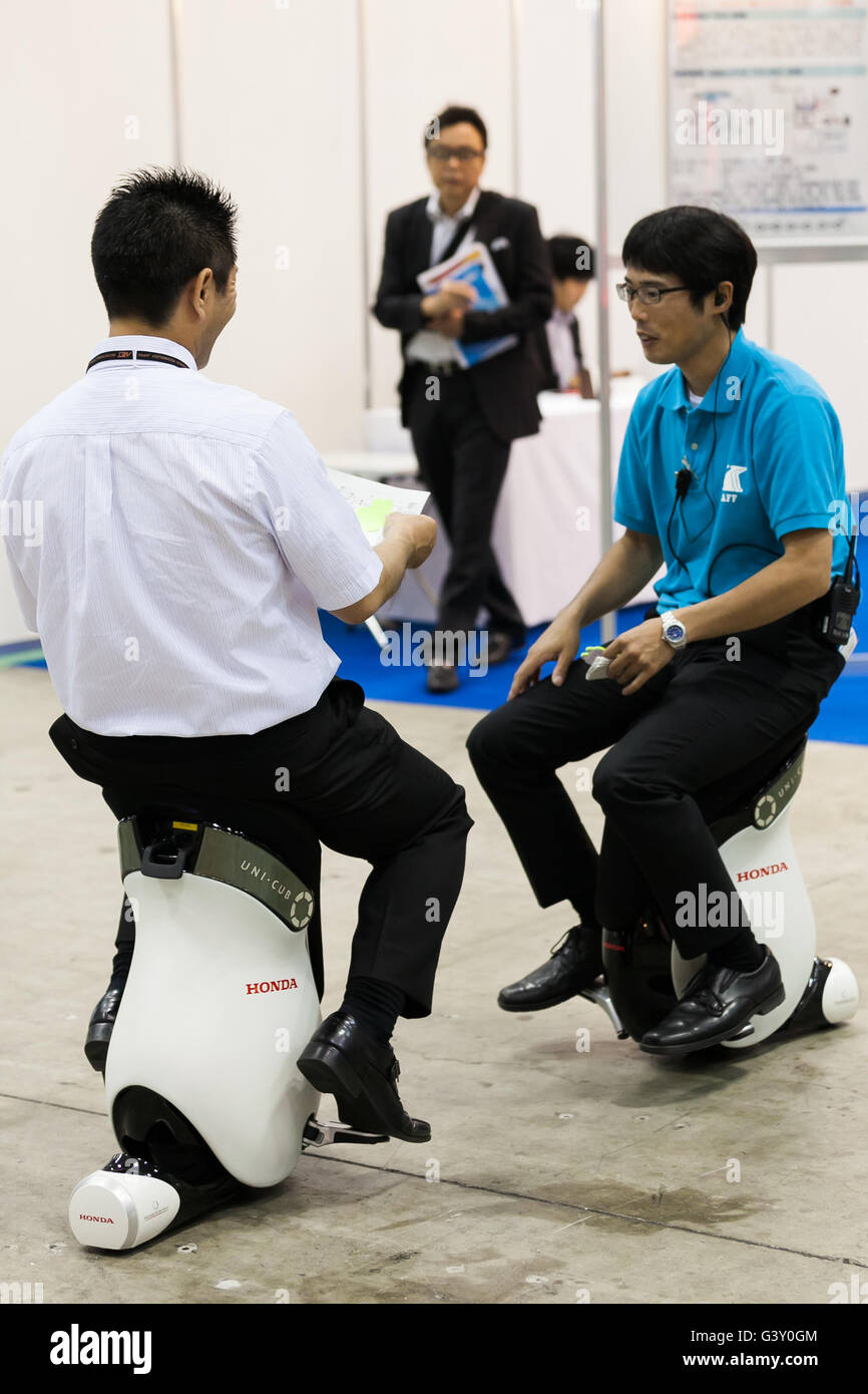 Tokyo, Japan. 16th June, 2016. An exhibitor teaches to a visitor how to drive a personal device ''UNI-CUB'' at the Smart Community Japan 2016 show at Tokyo Big Sight on June 16, 2016, Tokyo, Japan. Smart Community Japan promotes the latest technology related to energy security and efficiency over three days at Tokyo Big Sight. This year 296 enterprises and organizations are showing their products. Organisers reported 12,391 visitors on June 15th, the first day of the show. Credit:  Rodrigo Reyes Marin/AFLO/Alamy Live News Stock Photo