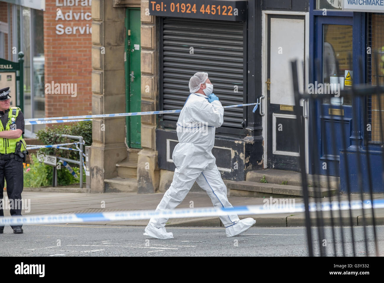 Market Street, Birstall, West Yorkshire, UK. 16th June, 2016. A crime scene investigator in Chapel Lane,  a short distance from the scene of the shooting. Credit: Ian Wray Alamy Live News Stock Photo