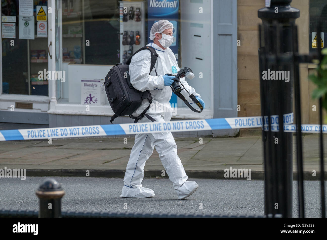 Market Street, Birstall, West Yorkshire, UK. 16th June, 2016. A crime scene investigator in Chapel Lane,  a short distance from the scene of the shooting. Credit: Ian Wray Alamy Live News Stock Photo