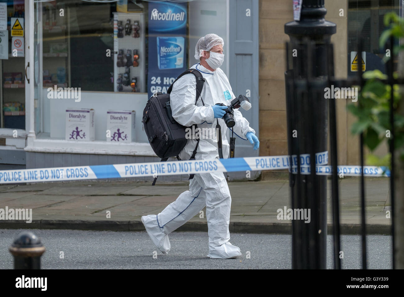 Market Street, Birstall, West Yorkshire, UK. 16th June, 2016. A crime scene investigator in Chapel Lane,  a short distance from the scene of the shooting. Credit: Ian Wray Alamy Live News Stock Photo