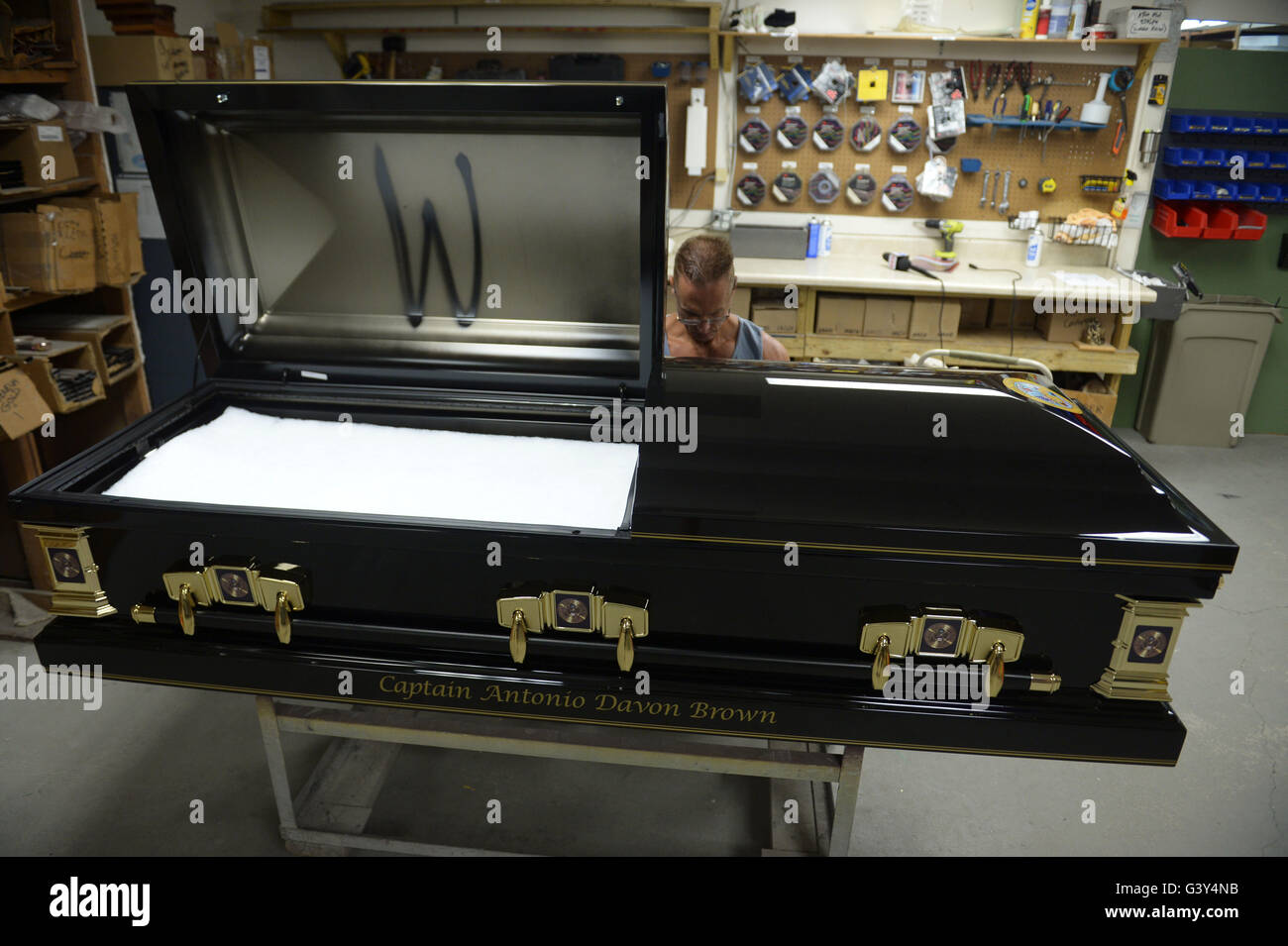 Orlando, USA. 16th June, 2016. A worker prints the name of a victim of shooting spree at Pulse nightclub to his coffin in Cardinal Casket Company in Orlando, the United States, June 16, 2016. Funeral preparations for victims were underway as the city-owned Greenwood Cemetery would donate plots of land and the casket company had finished 24 coffins for victims. Credit:  Yin Bogu/Xinhua/Alamy Live News Stock Photo